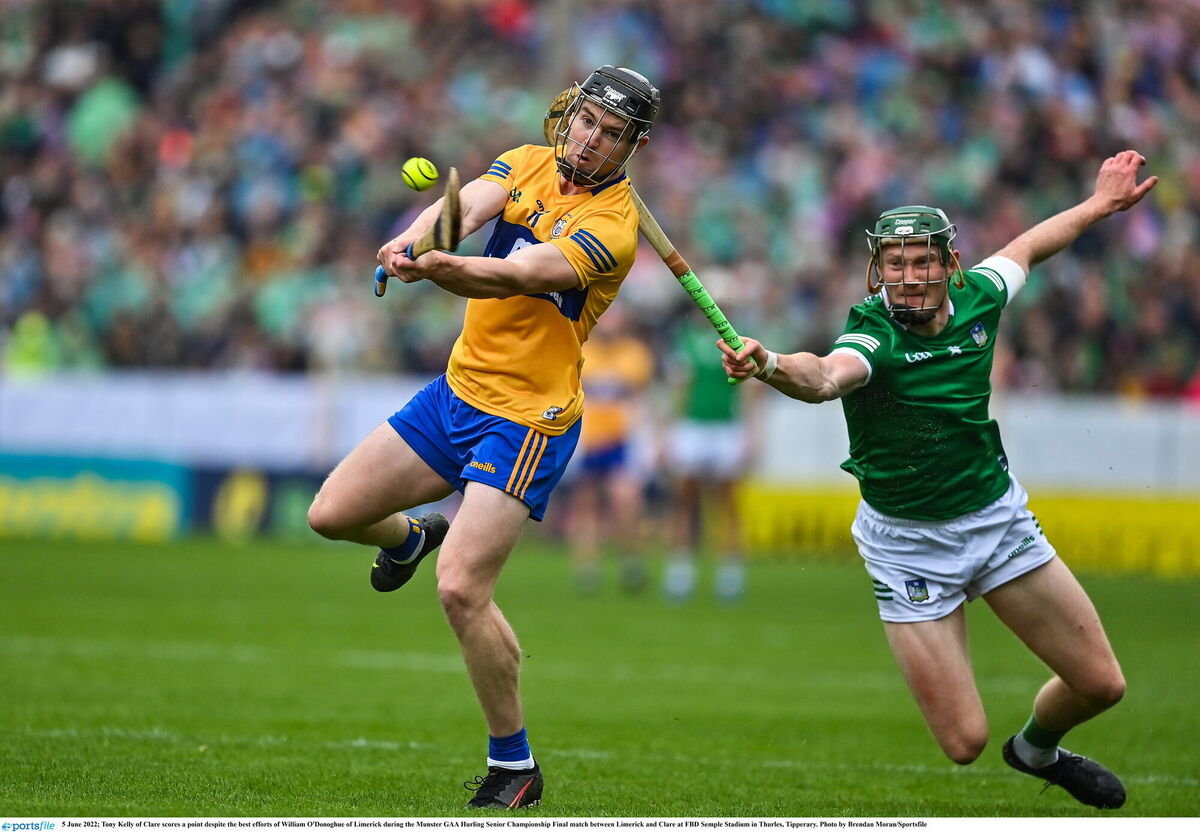 Tony Kelly of Clare scores a point despite the best efforts of William O'Donoghue. Picture: Brendan Moran/Sportsfile