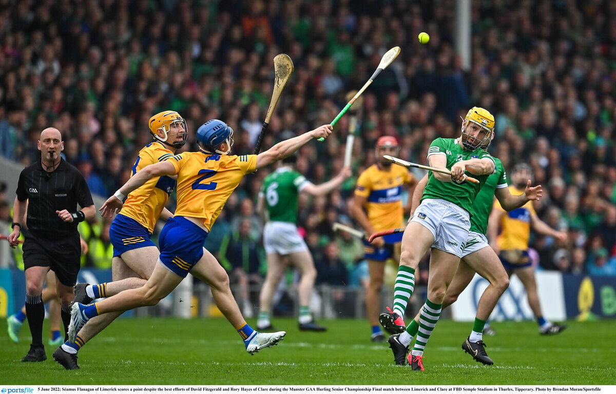 Séamus Flanagan of Limerick scores a point despite the best efforts of David Fitzgerald and Rory Hayes of Clare. Picture: Brendan Moran/Sportsfile