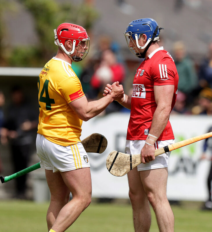 Antrim's Conor Johnston with Cork's Sean O'Donoghue at the final whistle. Picture: INPHO/John McVitty