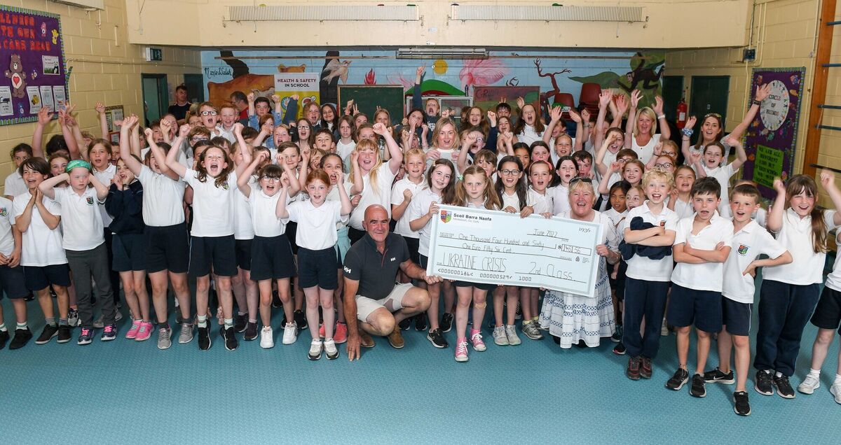  Pupils along with teaching staff members and friends of Scoil Barra Naofa, Monkstown, presenting a cheque to Caitriona Twomey of Cork Penny Dinners and Kieran Coniry of The Port of Cork. The funds were raised in aid of the Ukraine crisis. Picture: David Keane