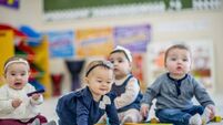 Cute babies playing with toys in daycare