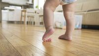 Baby boy taking first steps