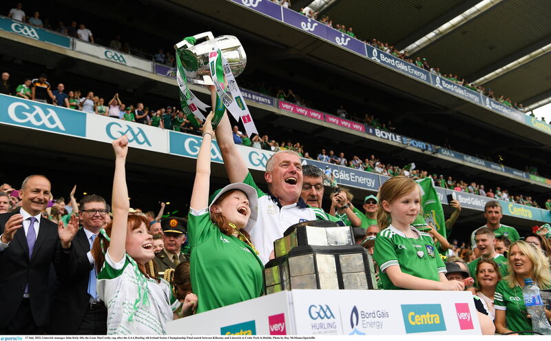 Limerick manager John Kiely lifts the Liam MacCarthy Cup with his family. Picture: Ray McManus/Sportsfile