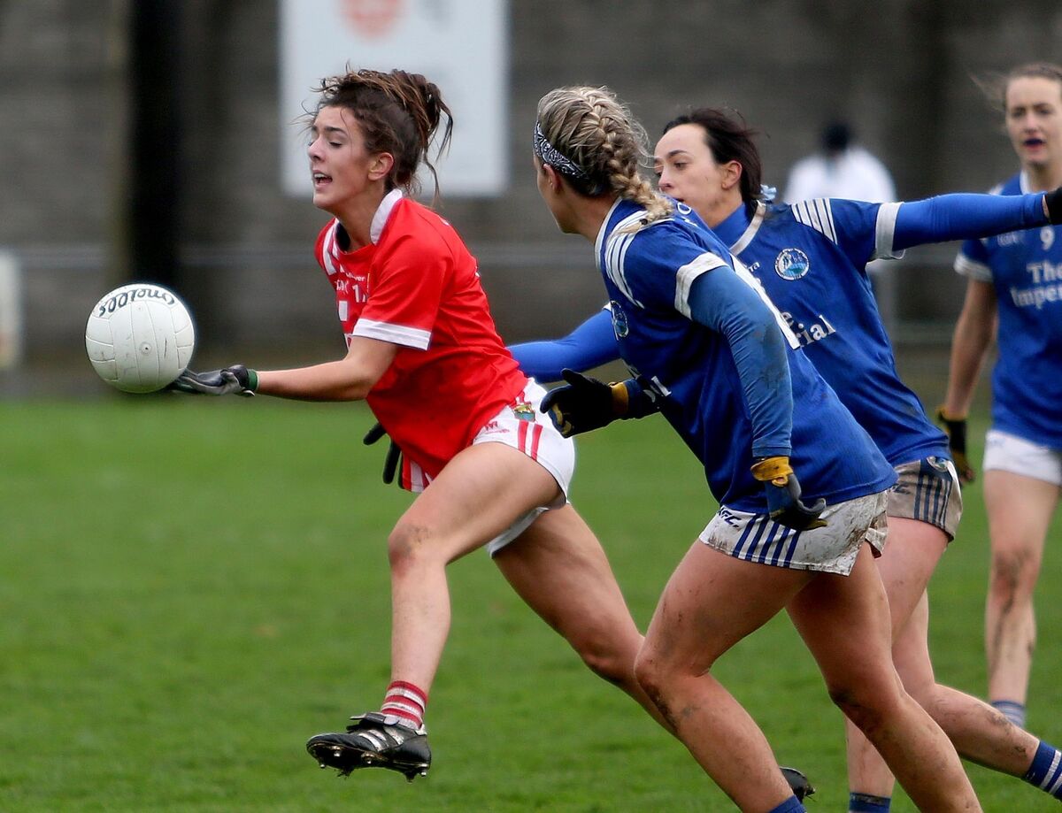 Erika O'Shea of Cork getting away from Cavan players Geraldine Sheridan and Donna English.