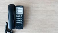 The old black phone on the business office desk in the wood be used for contact Connect, above on table top view Employees are w
