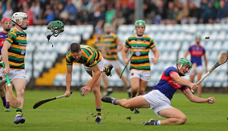 Brian Moylan, Glen Rovers, loses his helmet after a clash with Robbie O'Flynn of Erin's Own.Picture: Jim Coughlan.