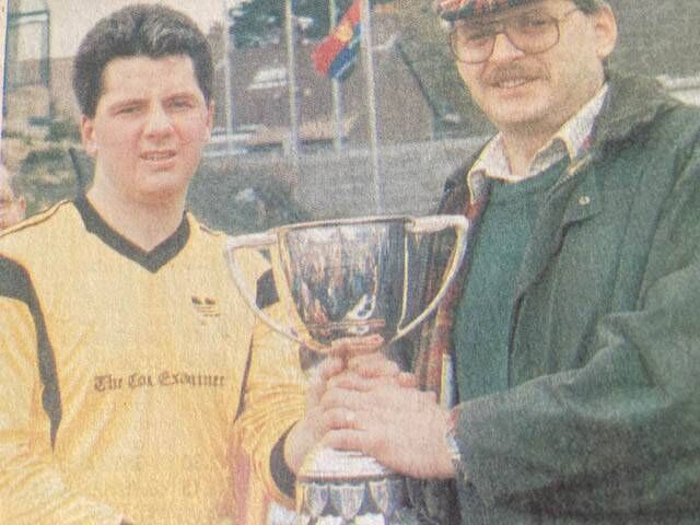 Michael O'Driscoll, sponsor, presents the AIB Cup to victorious Cork Examiner vice-captain Kieran Falvey following the 1-0 win over Centra at Turner's Cross in 1992. 