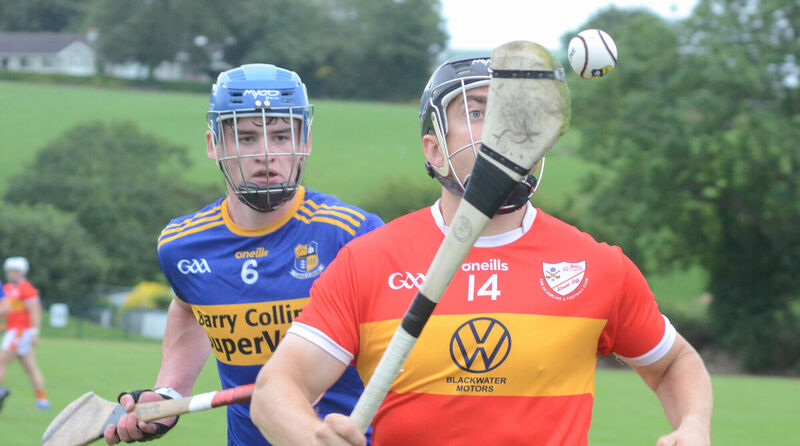 Éire Óg's Kevin Hallissey keeps his eye on the sliotar as Carrigaline's Rhys McCarthy looks on. Picture: Howard Crowdy