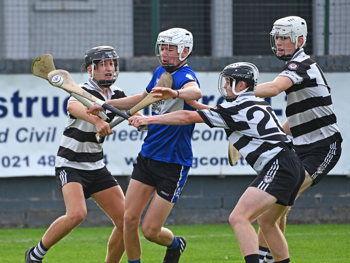 Sarsfields' Adam McCarthy is tackled by Midleton's Daragh Egan, Eoghan Fraser and Tadgh Bohan during the Rebel Óg P1 MHC recently at Riverstown. Picture: Eddie O'Hare