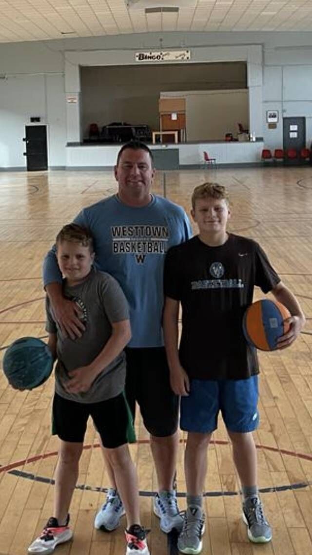 Coach Paul Manning with his two sons Cian and Luke at the Parochial Hall during a coaching session for the Cork County Basketball Board.