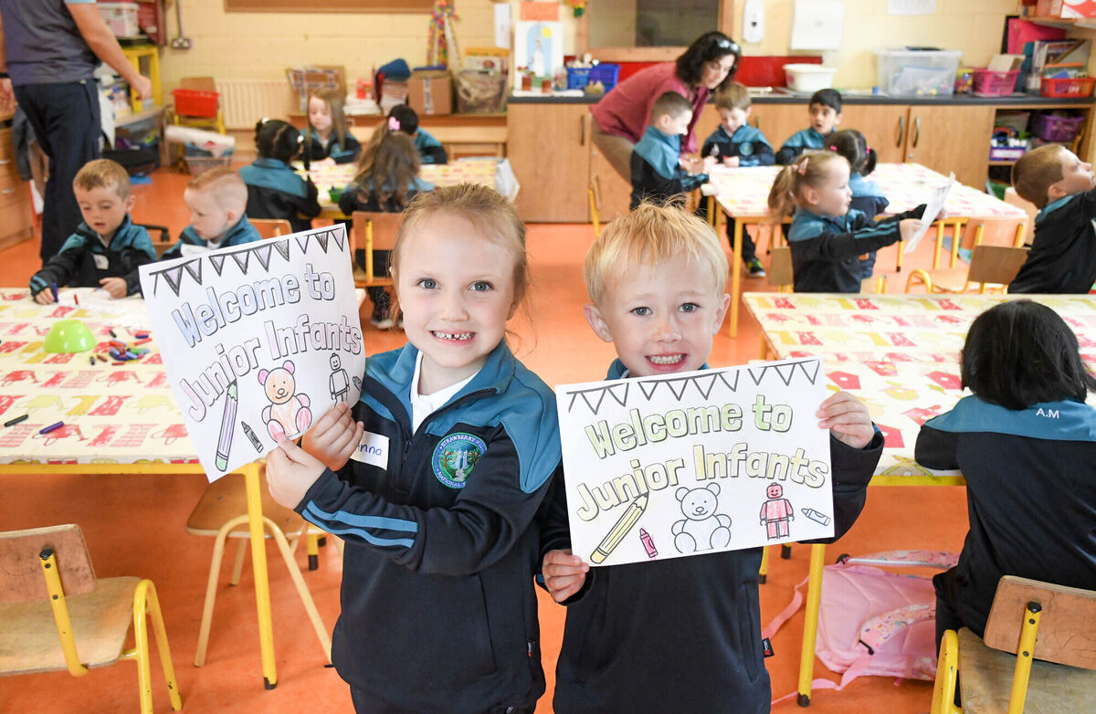 Anna Long and Ollie Carroll seen with their 'Welcome to Junior Infants' posters on their first day in Michelle O'Mahony's junior infants class at Strawberry Hill NS. Picture: Howard Crowdy