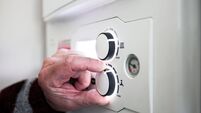 A pensioner adjusting the temperature control on his combi boiler. Redcar, UK. 26/5/2021. Photograph: Stuart Boulton.
