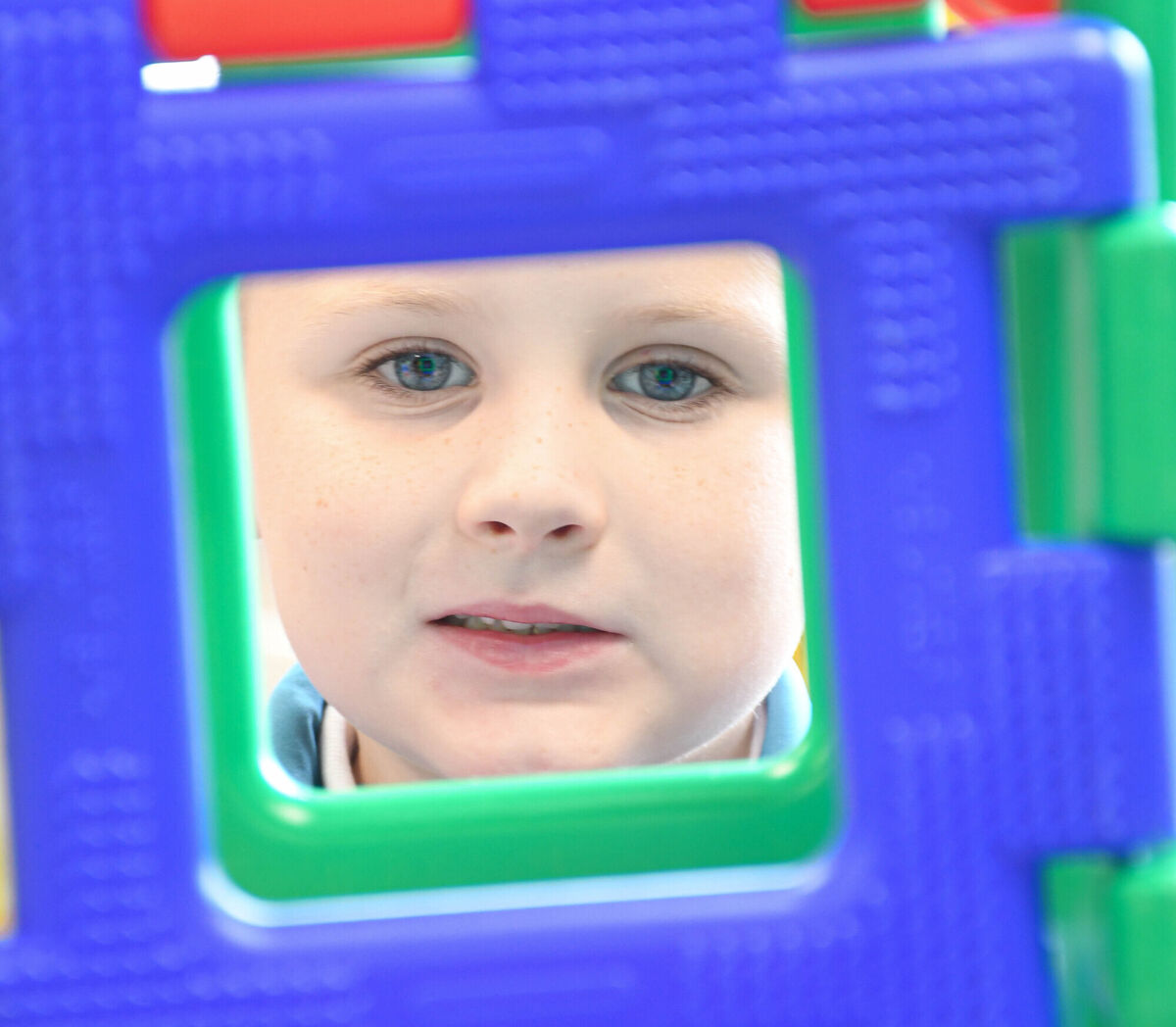  Fionn Buckley pictured looking through a tower of blocks on his first day.
