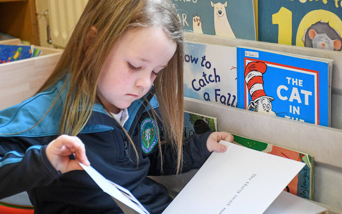 Chloe McCarthy O'Sullivan pictured amongst the books in Michelle O'Mahony's Junior infants class at Strawberry Hill NS. 