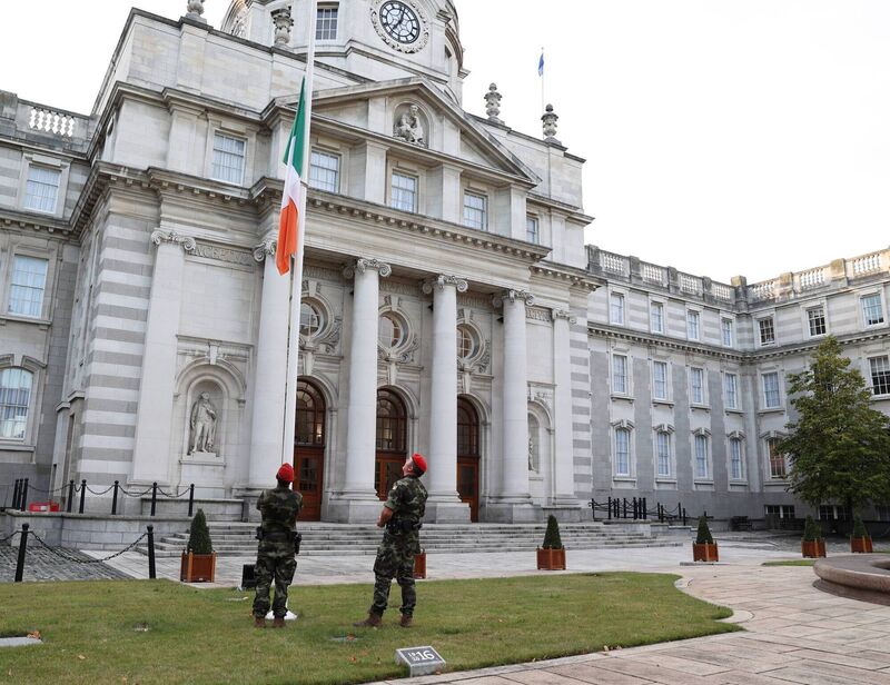 Defence Forces military police lower the Irish flag to half mast outside government buildings in Dublin after the accouncement of the death of Queen Elizabeth II today 08 September 2022 Photograph Government Information Service Defence Forces military police lower the Irish flag to half mast outside government buildings in Dublin after the accouncement of the death of Queen Elizabeth II today 08 September 2022 Photograph Government Information Service
