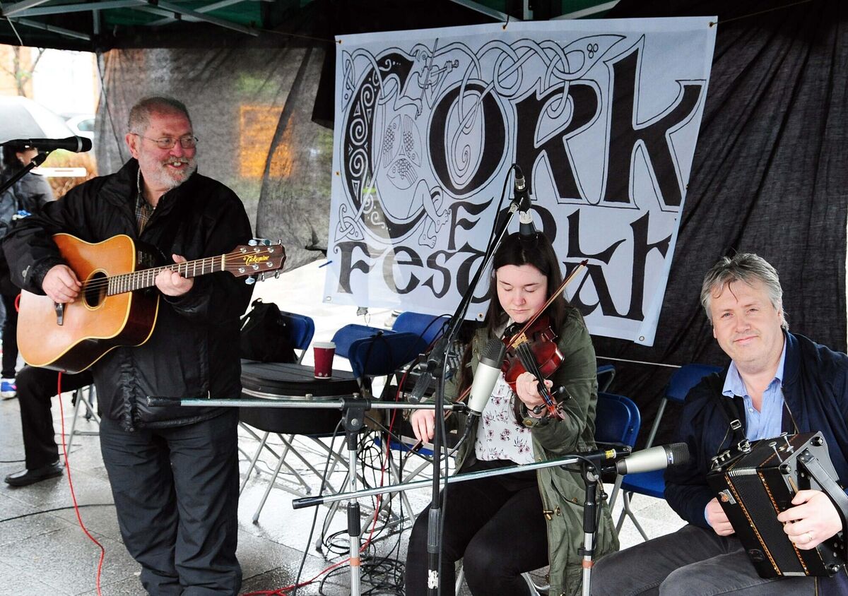 John Nyhan (left) with Micheál and Aoife Foley singing and playing music at the food and folk event at Emmet Place during Cork Folk Festival in 2017. Picture: Denis Minihane.