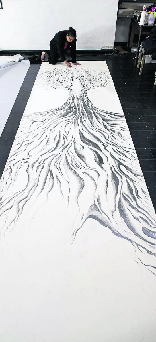 Artist Hina Khan with one of her artworks