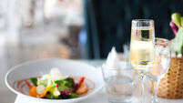 Dinner with sea food salad and champagne glass