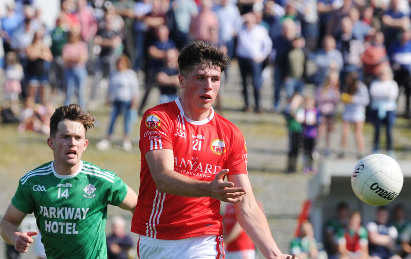 O'Donovan Rossa's Rory Byrne hand-passing the ball clear of Dohenys' Keith White. Picture Denis Minihane.