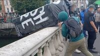 Coffin marked 'RIP British Empire' thrown into Liffey during anti-monarchy march