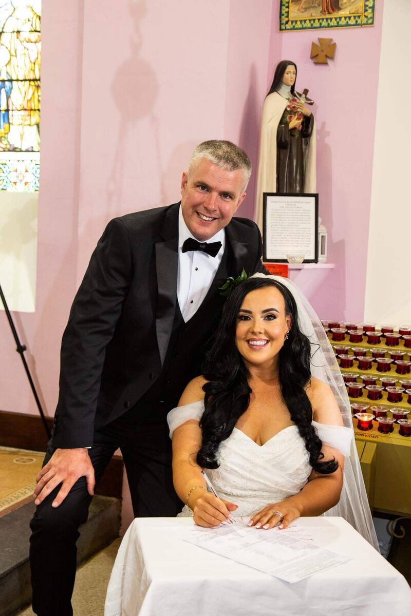 The pair signing the register.