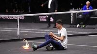 Protester sets his arm on fire during Laver Cup match in London