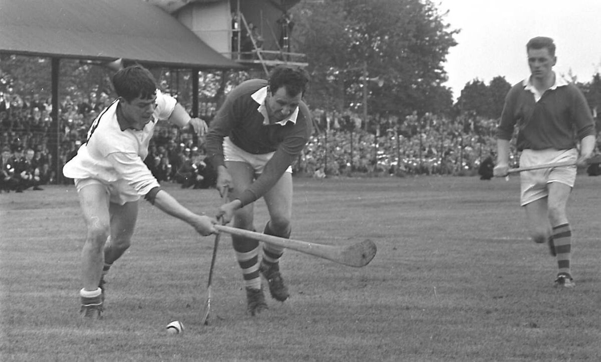 Waterford corner-forward Danny Mahon, Mount Sion, tussles with Cork keeper Paddy Barry, St Vincent's.