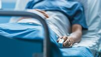In the Hospital Sick Male Patient Sleeps on the Bed. Heart Rate Monitor Equipment is on His Finger.