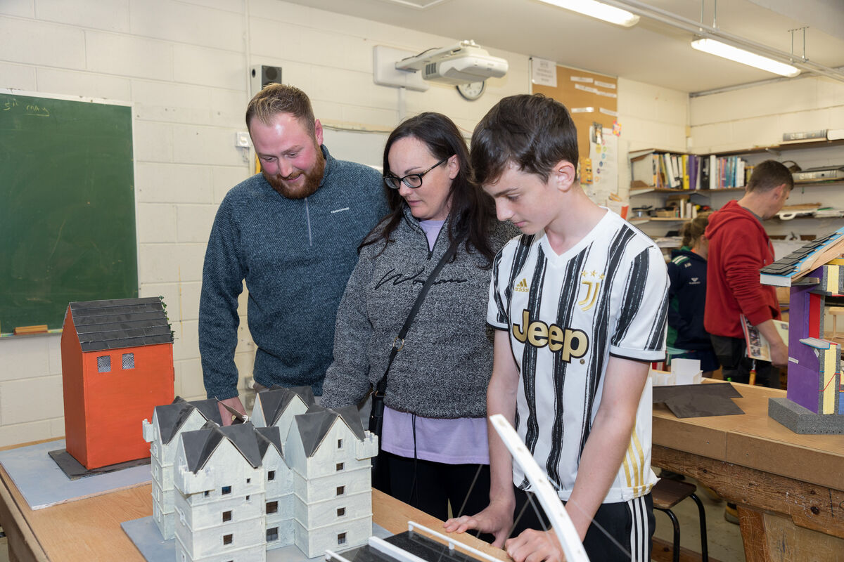 Gary, Ciara and Harry Tett looking at woodwork producded by the students at the open night which was held in St. Peter's Community School in Passage West, Co. Cork. - Picture David Creedon
