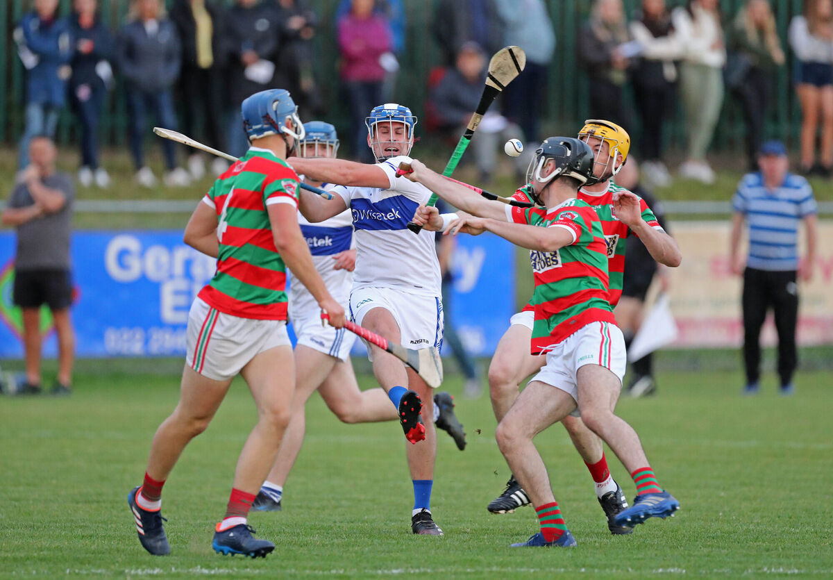  Henry O'Gorman, Milford, is swarmed by Rory Sinclair, Darragh Kidney and Graham Webb, Tracton. Picture: Jim Coughlan.