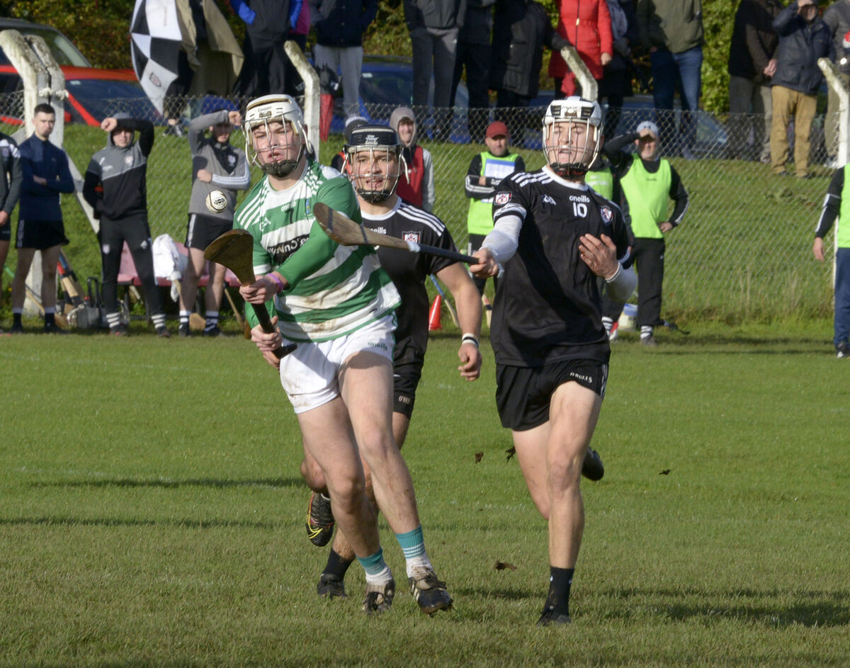 Midleton's Michael Finn and Tadhg O'Leary Hayes chasing Valley Rovers Jonathan O'Leary. Picture: Denis Boyle