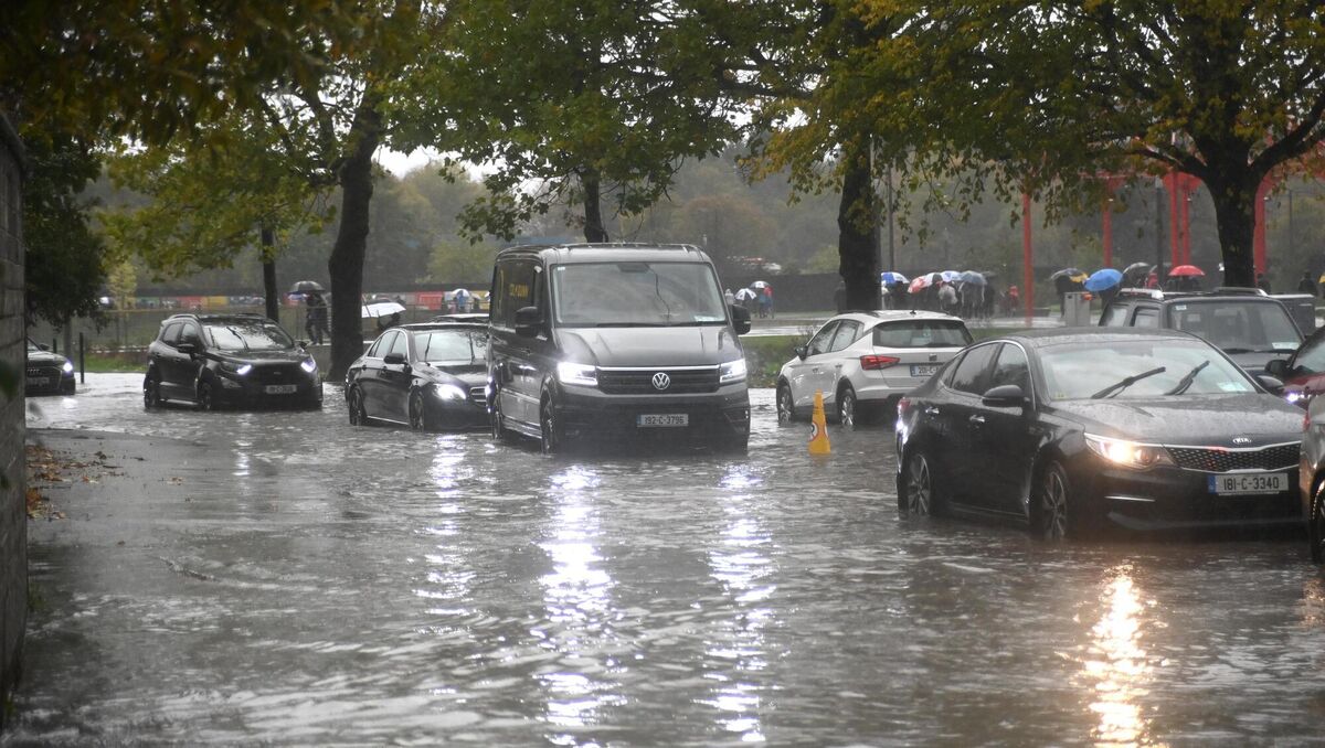 Vehicles pass through flood water on Monahan Road as crowds departed Pairc Ui Chaoimh on Sunday. Picture: Larry Cummins