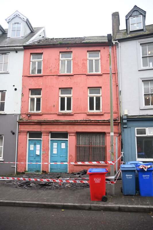 Cork City Fire Brigade crews were called out to deal with a potentially dangerous building on Barrack Street in the midst of the weather warning on Wednesday, as old roofing material on the building had come loose. Pic: Larry Cummins