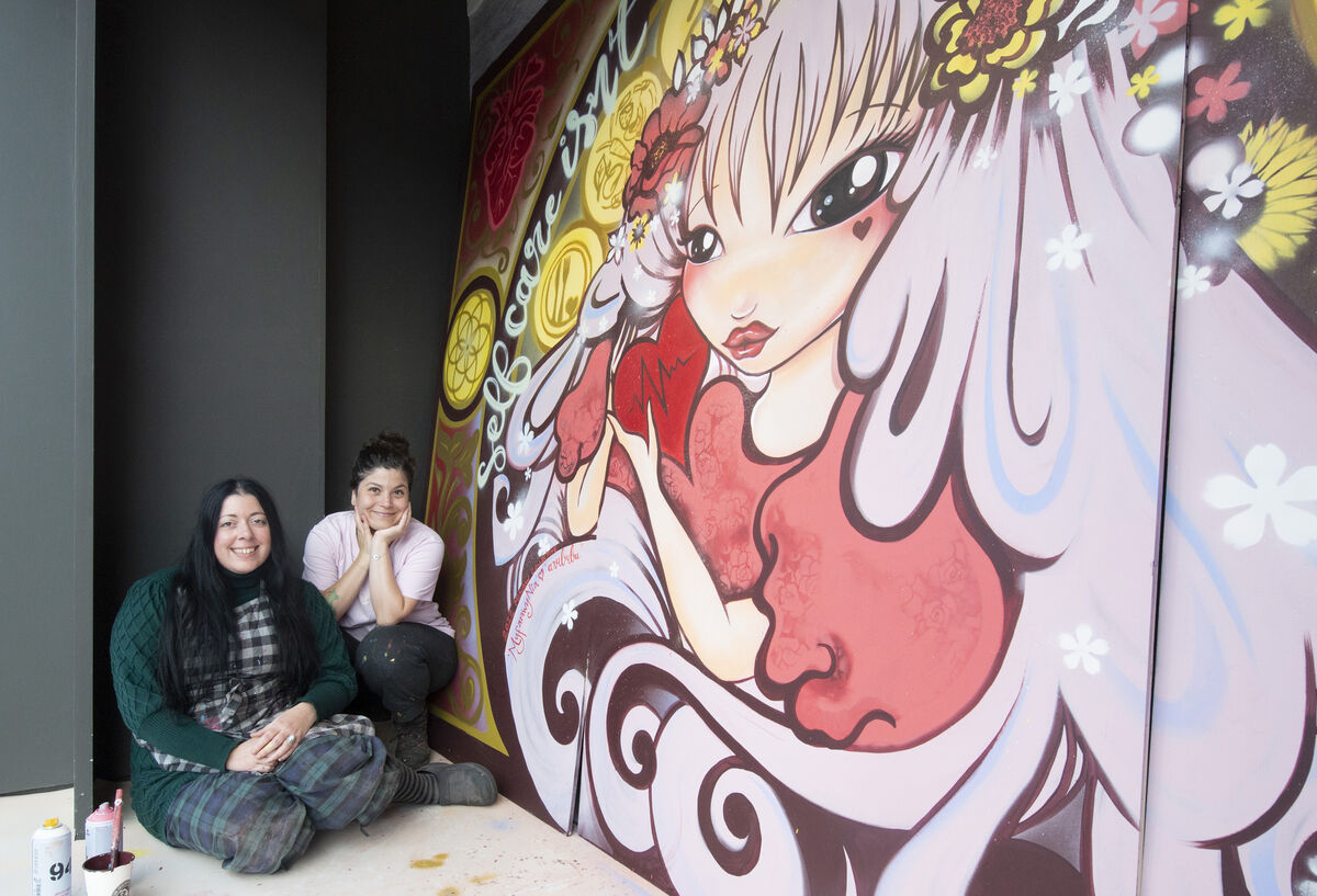 The Irish Heart Foundation has teamed up with the all-female art collective – the Minaw Collective – to create a number of vibrant heart-inspired murals across Marks & Spencer windows in Dublin and Cork to celebrate the finale of the month-long 'Her Heart Matters' campaign. Pictured here are artists Myfanwynia and Bubu bringing their mural to life in the window of Marks & Spencer on Patrick Street, Cork. Picture: Gerard McCarthy The Irish Heart Foundation has teamed up with the all-female art collective – the Minaw Collective – to create a number of vibrant heart-inspired murals across Marks & Spencer windows in Dublin and Cork to celebrate the finale of the month-long 'Her Heart Matters' campaign. Pictured here are artists Myfanwynia and Bubu bringing their mural to life in the window of Marks & Spencer on Patrick Street, Cork. Picture: Gerard McCarthy
