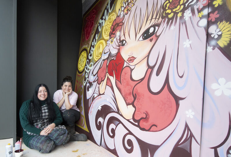 The Irish Heart Foundation has teamed up with the all-female art collective – the Minaw Collective – to create a number of vibrant heart-inspired murals across Marks &amp; Spencer windows in Dublin and Cork to celebrate the finale of the month-long 'Her Heart Matters' campaign. Pictured here are artists Myfanwynia and Bubu bringing their mural to life in the window of Marks &amp; Spencer on Patrick Street, Cork. Picture: Gerard McCarthy