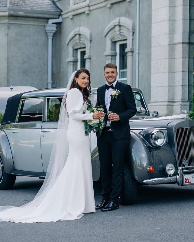 The couple with their wedding car, outside Faithlegg House Hotel, where they enjoyed their wedding reception surrounded by family and friends.