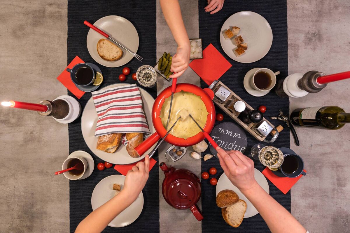 People enjoying a Swiss cheese fondue party. Picture: Alamy/PA. WARNING: This picture must only be used to accompany PA Feature LIFE Autumn.