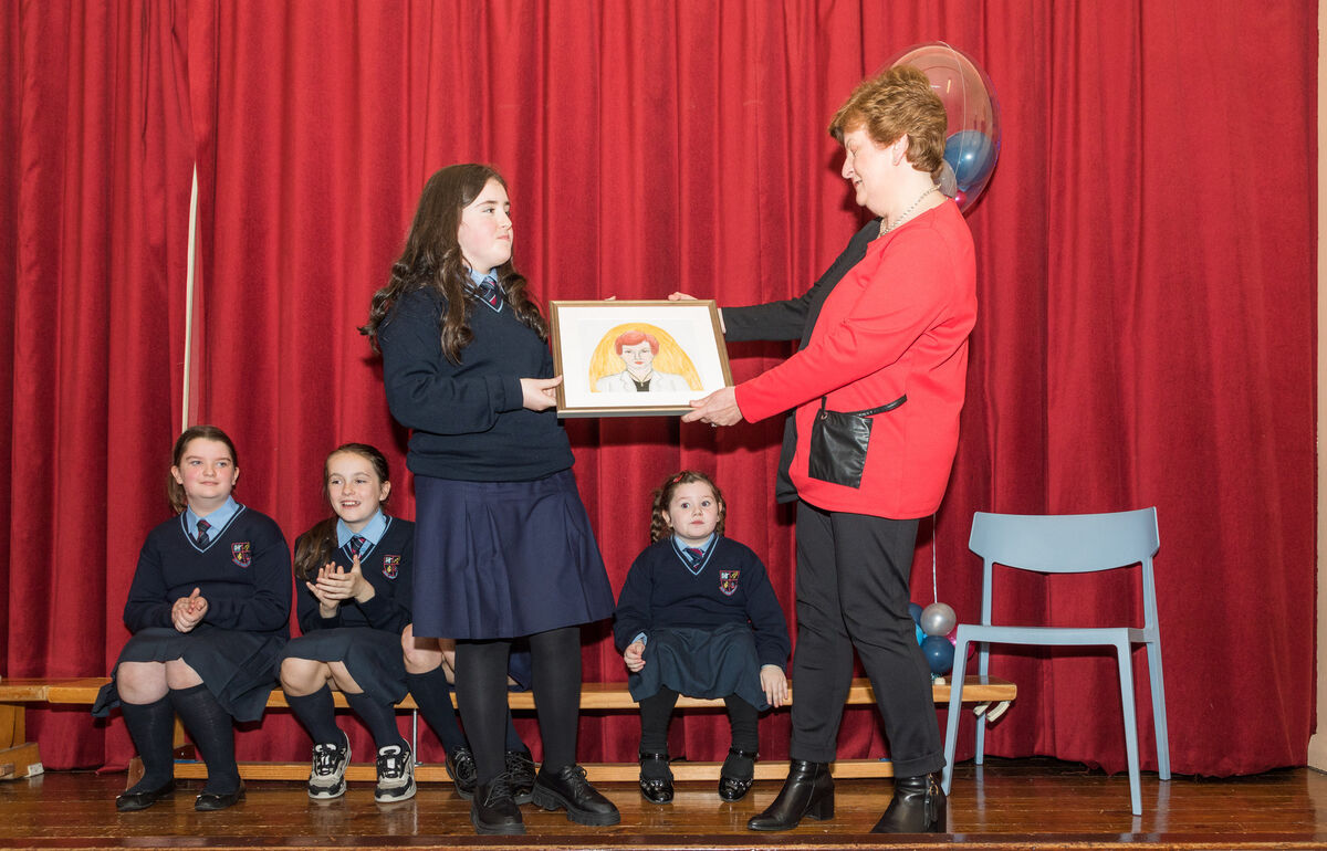 School principal Teresa O'Sullivan receives a presentation from 5th Class pupil Allanah Hickey to mark her retirement from teaching after twenty seven years at Scoil Aiseiri Chriost in Farranree, Cork.Picture David Creedon