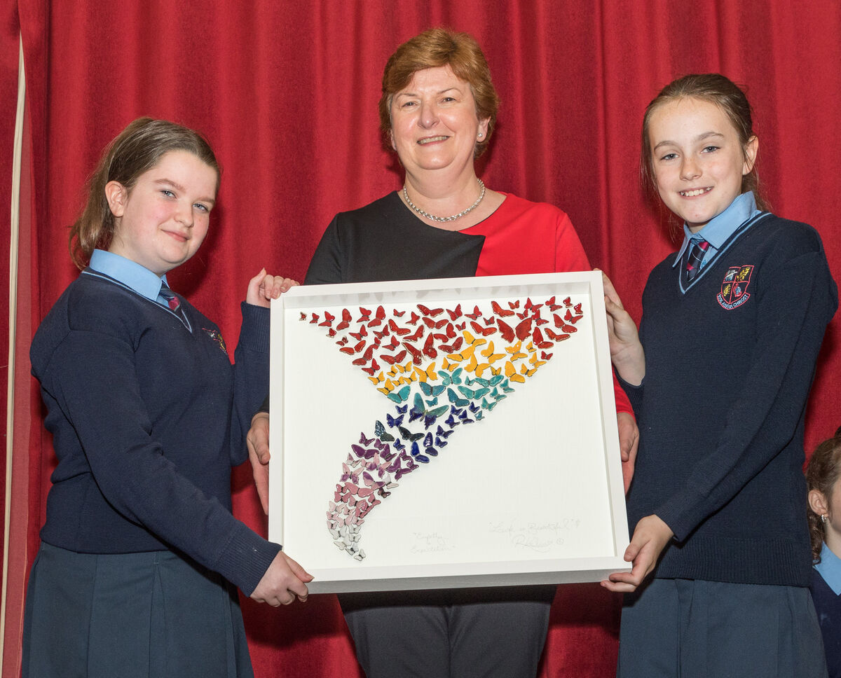 School principal Teresa O'Sullivan receives a presentation from 6th Class pupils Jodie Murphy and Sophie Barrington to mark her retirement from teaching after twenty seven years at Scoil Aiseiri Chriost in Farranree, Cork. Picture David Creedon