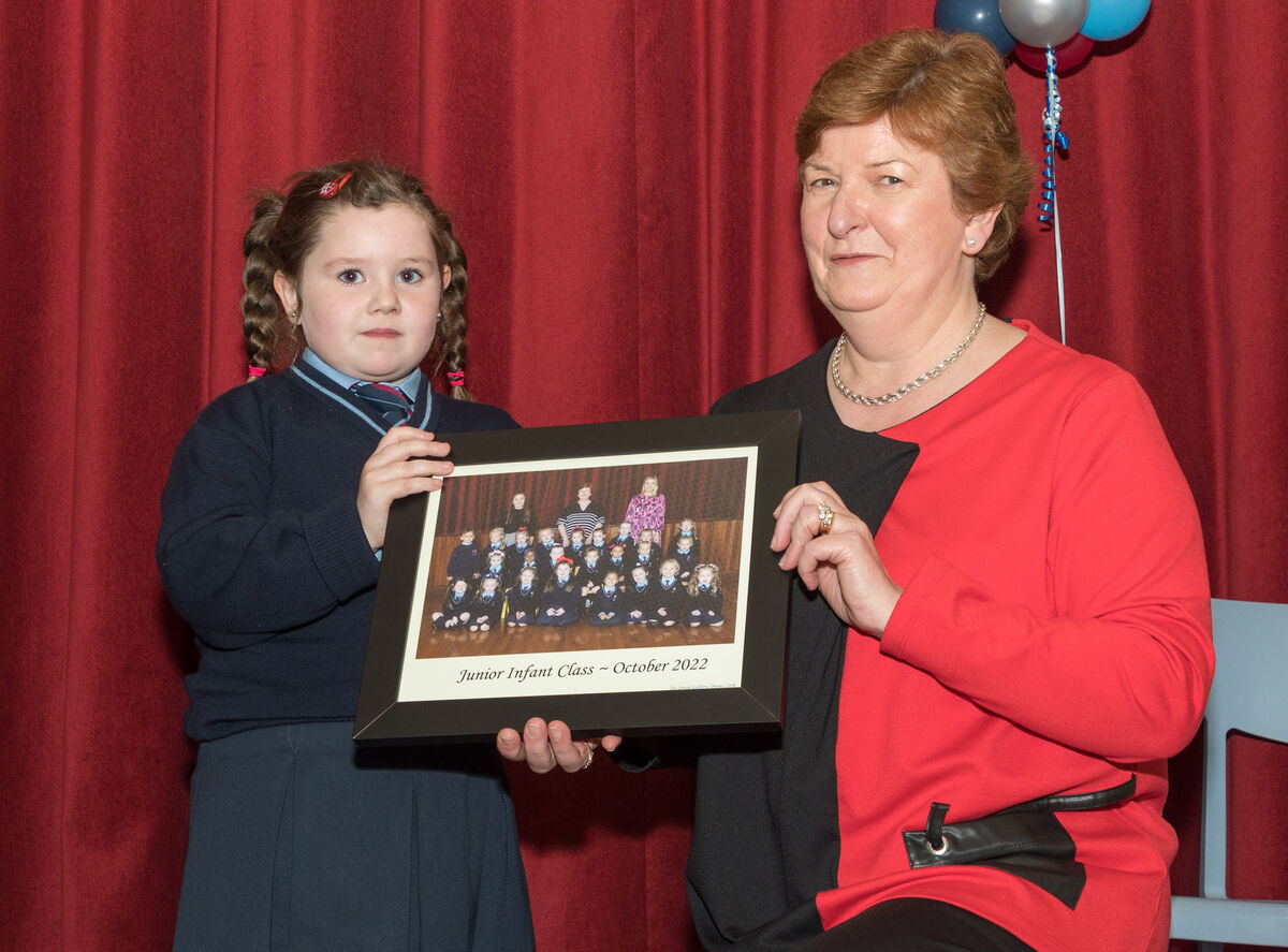 School principal Teresa O'Sullivan receives a presentation from pupil Saoirse Hickey to mark her retirement from teaching after twenty seven years at Scoil Aiseiri Chriost in Farranree, Cork. Picture David Creedon