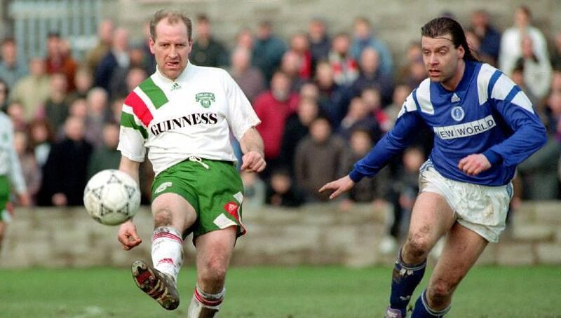 Dave Barry steers the ball away from Ken De Mange at Turner's Cross.