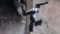 Banksy reveals artwork on side of damaged building in Ukraine
