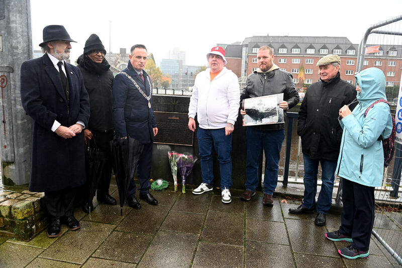Relatives of those who lost their lives and others who wished to mark the anniversary of the tragedy gathered at the commemorative plaque on Michael Collins Bridge. 