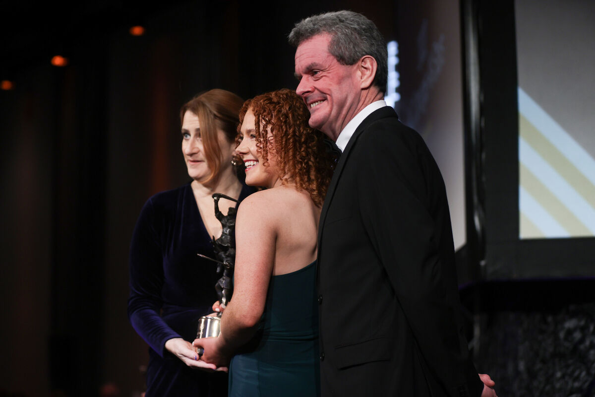 Maggie Coppinger on behalf of Libby Coppinger (Cork) is presented with her PwC Camogie All-Star Award by Uachtarán Hilda Breslin and PWC’s Markets Partner David McGee