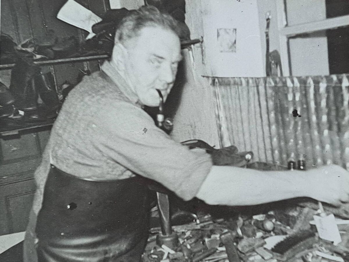 The cobbler Albert Willis at his work bench in Lucia Place, Passage West The cobbler Albert Willis at his work bench in Lucia Place, Passage West