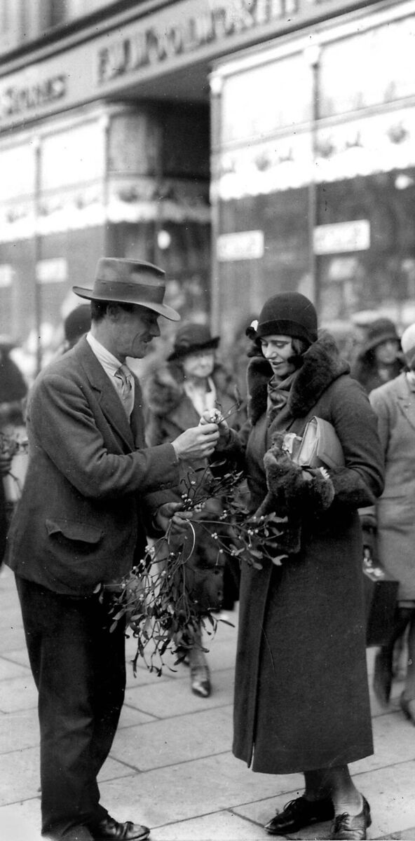CHRISTMAS IN THE CITY: A woman selling mistletoe outside Woolworth’s store in Patrick Street, Cork city, in December, 1931
