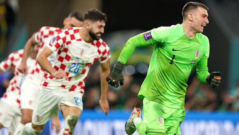 Croatia goalkeeper Dominik Livakovic (right) celebrates with team-mates after victory in the penalty shootout following extra time in the FIFA World Cup quarter-final at the Education City Stadium in Al Rayyan, Qatar. Picture: Mike Egerton/PA Wire