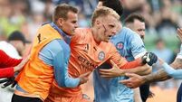 Melbourne derby abandoned after fans attack goalkeeper with metal bin