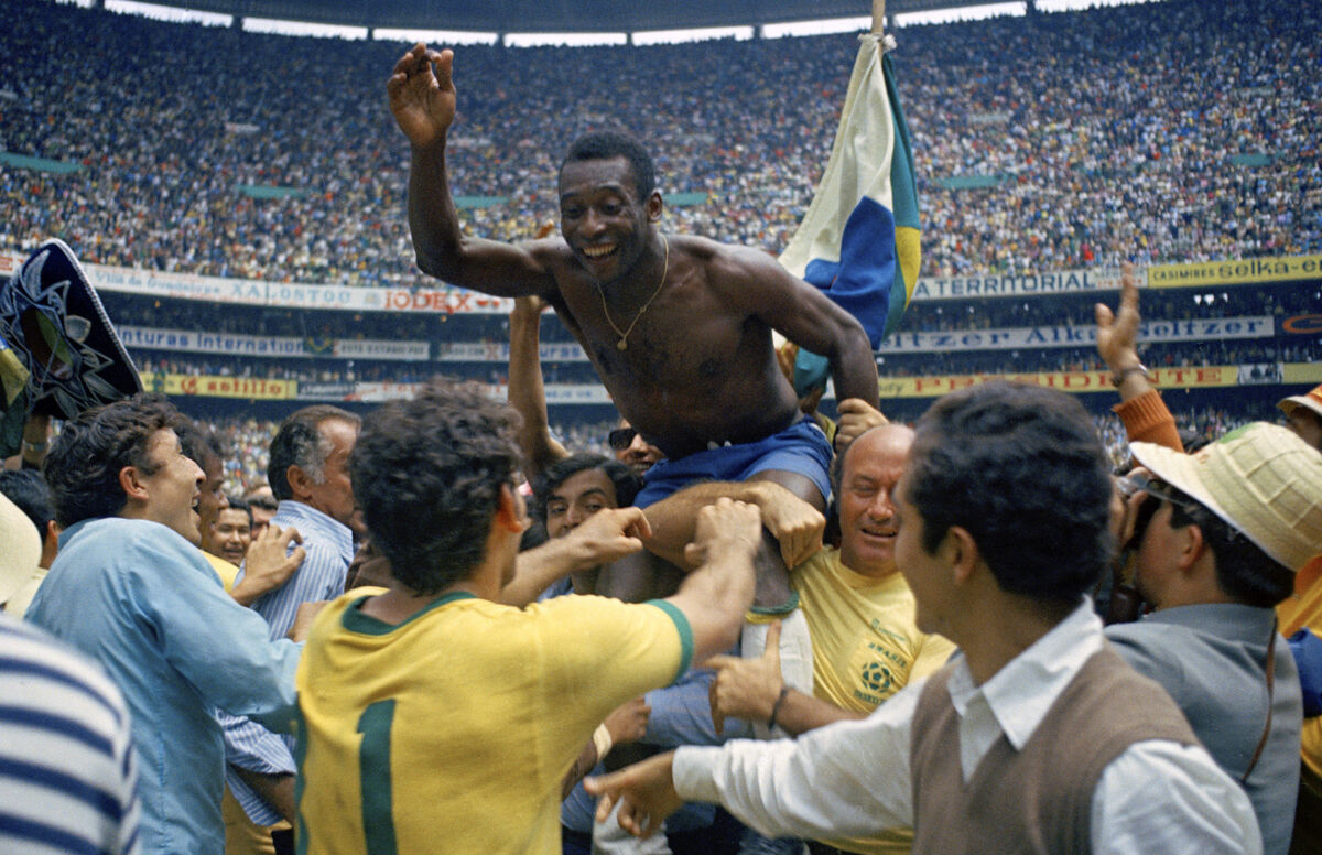 Brazil's Pele is hoisted on the shoulders of his teammates after Brazil won the World Cup final against Italy, 4-1, in Mexico City's Estadio Azteca, June 21, 1970. Pelé, the Brazilian king of soccer who won a record three World Cups and became one of the most commanding sports figures of the last century, died in Sao Paulo on Thursday, Dec. 29, 2022. (AP Photo, File)