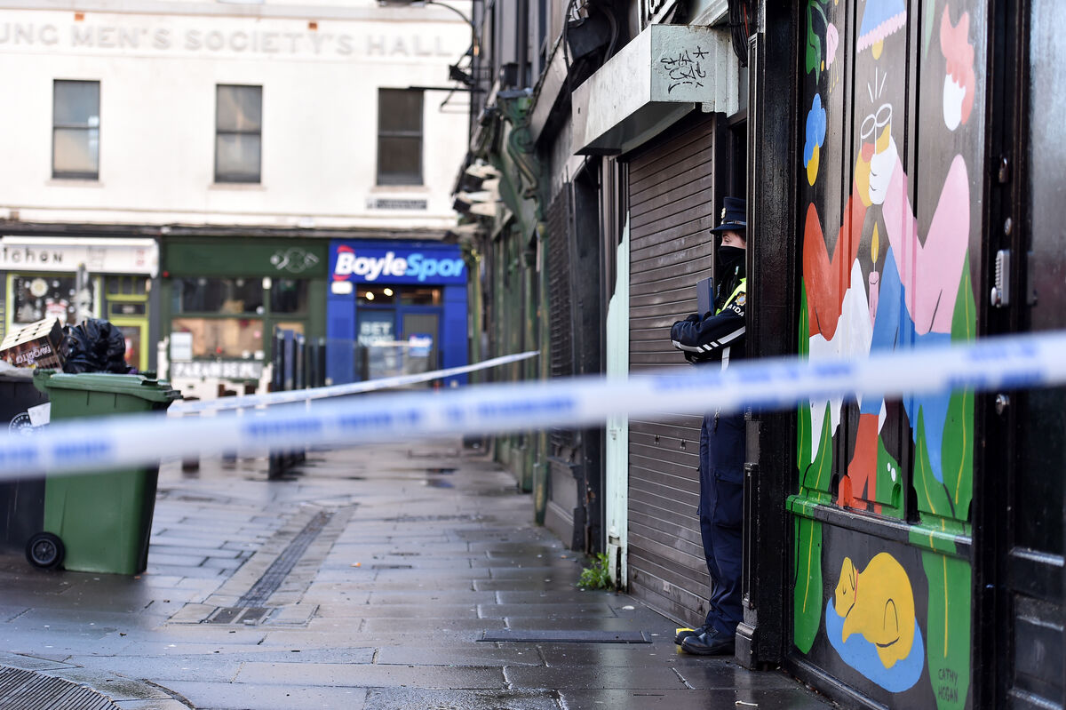  A Garda on duty at the entrance to a residence on Liberty Street, Cork where the body of a women i her 20s was discovered on New Year's Day. Picture Dan Linehan
